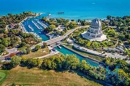 Aerial view of a waterfront marina and landmark building